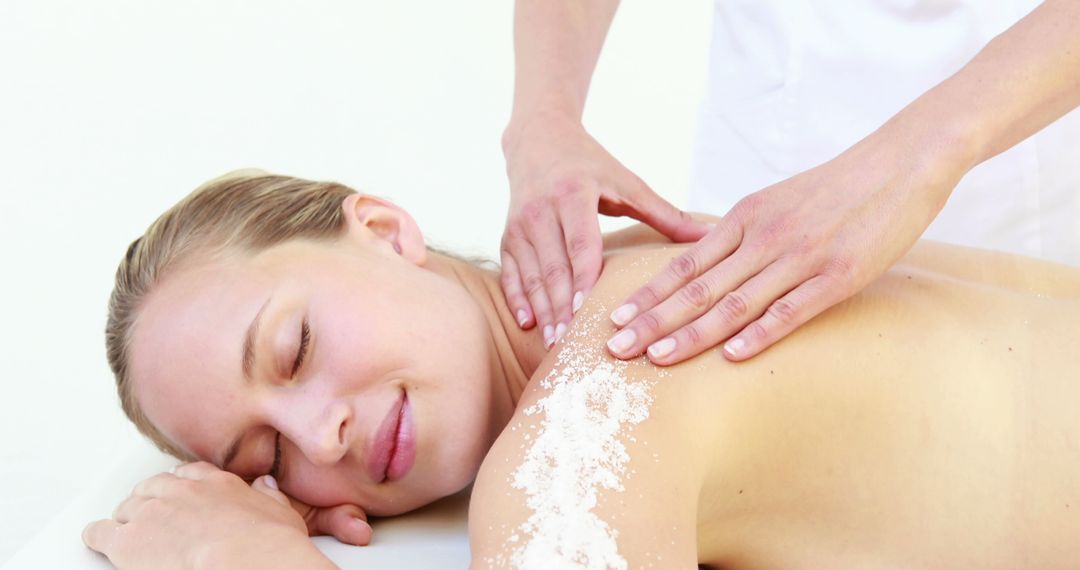 Woman receiving relaxing back massage with salt exfoliation - Free Images, Stock Photos and Pictures on Pikwizard.com