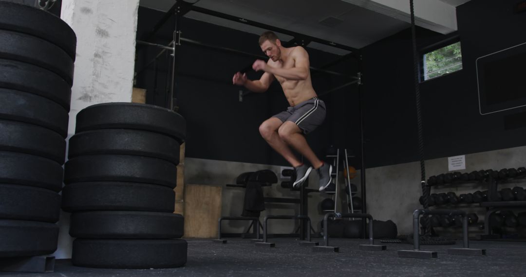 Athletic Man Performing Jump Workout in Gym