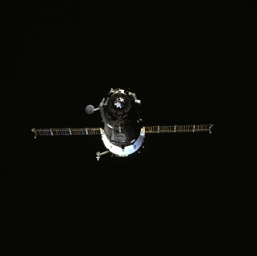 Soyuz spacecraft against dark space during shuttle Atlantis undocking, July 4, 1995 - Free Images, Stock Photos and Pictures on Pikwizard.com