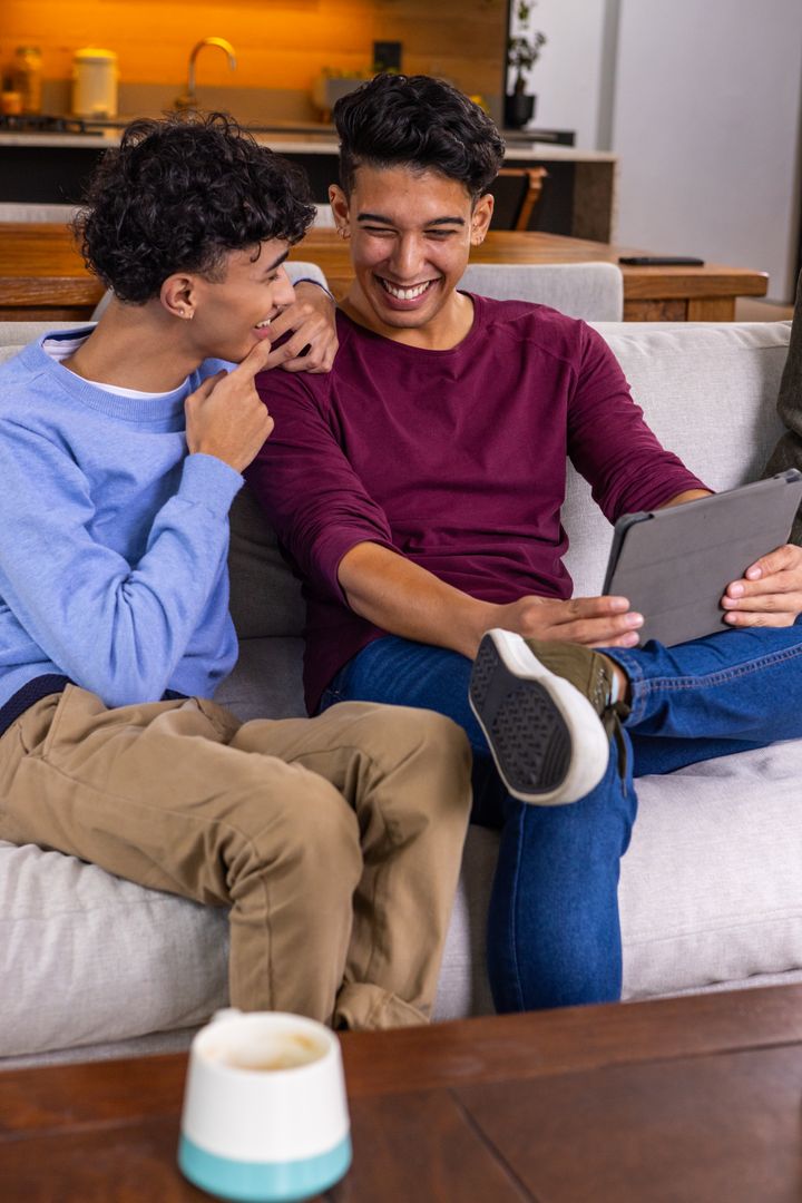 Smiling Friends Enjoying Tablet Together at Cozy Home