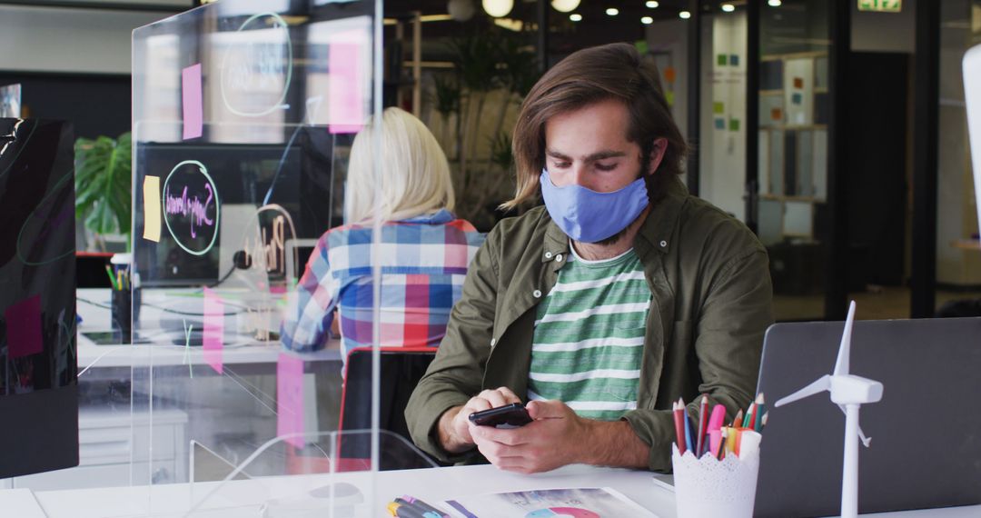 Businessman in Mask Using Smartphone in Modern Office Environment