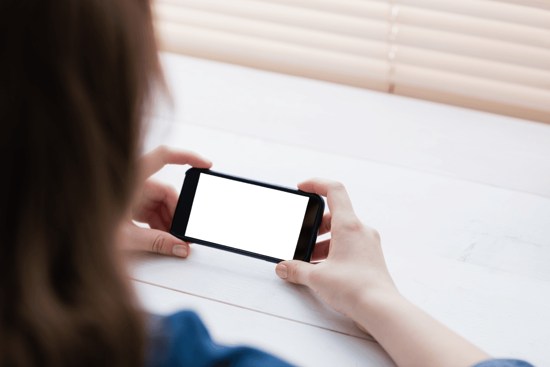 Businesswoman Checking Mobile Tech at Transparent Workspace Desk