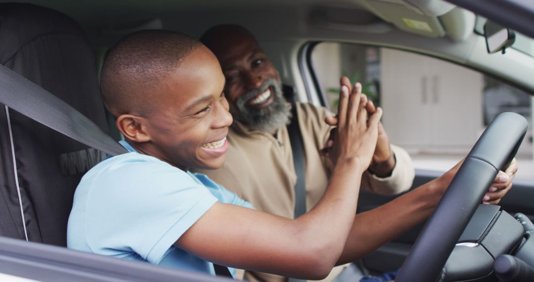 Image of happy african american father and son clapping hands in car - Free Images, Stock Photos and Pictures on Pikwizard.com
