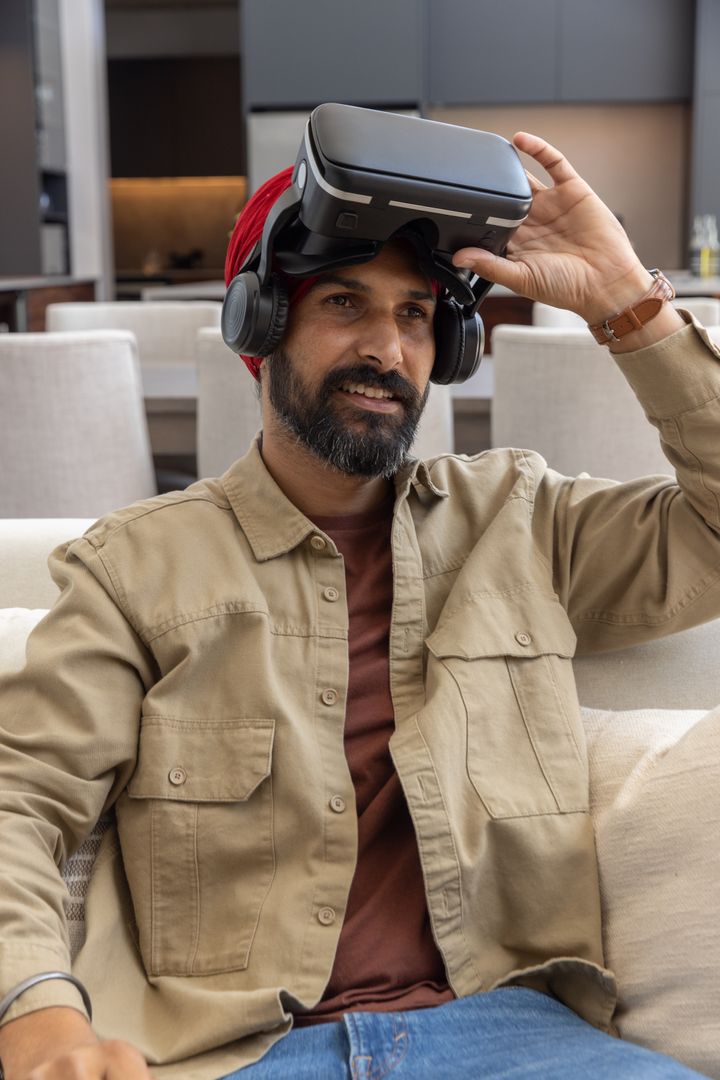 Indian Man Enjoying Virtual Reality at Home, Immersed in Modern Technology
