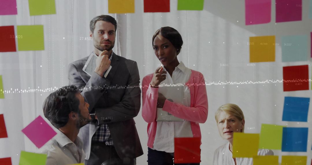 Diverse Team Collaborating on Project with Sticky Notes on Glass Wall