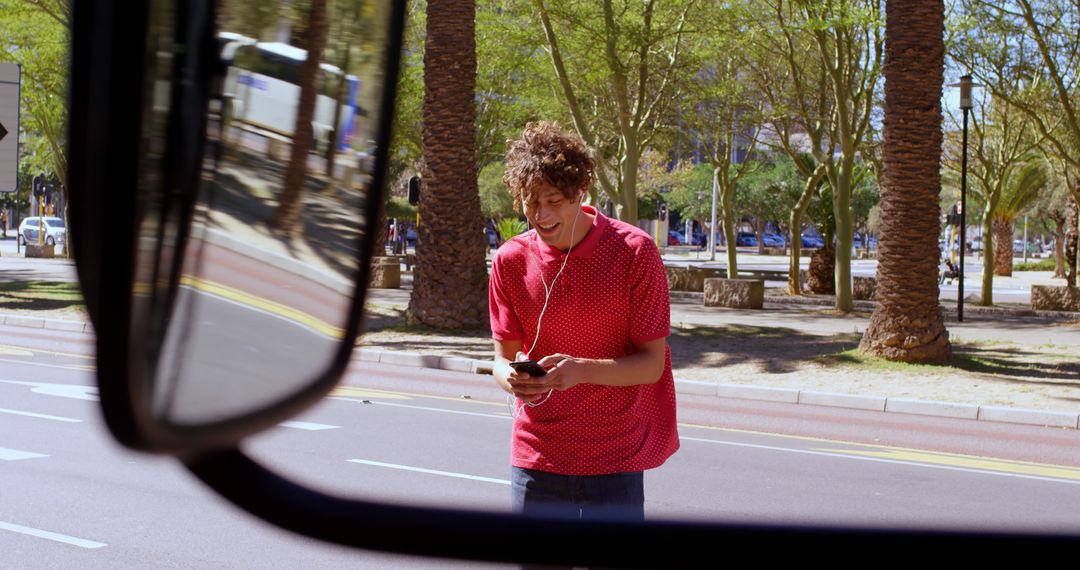 Young Man Walking and Using Smartphone in Busy Urban Street - Free Images, Stock Photos and Pictures on Pikwizard.com