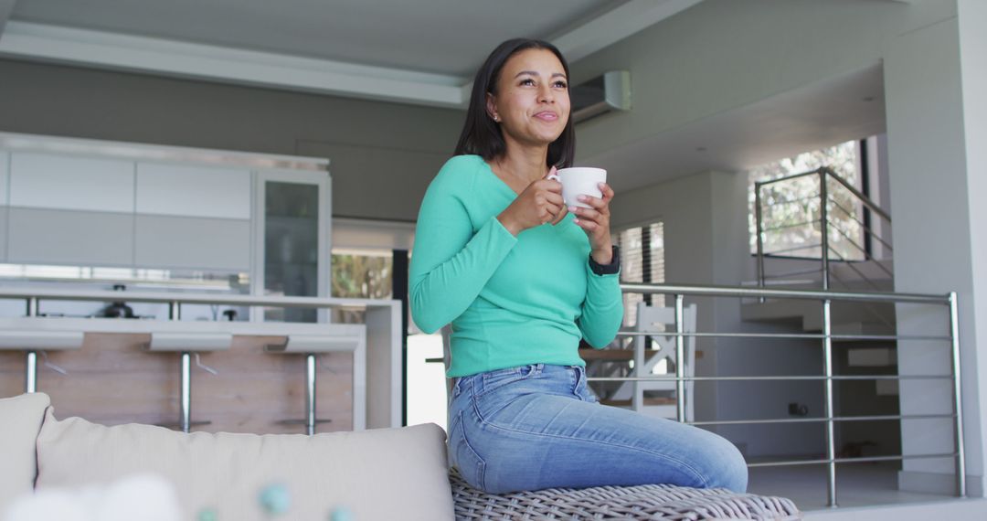 Relaxed Woman Drinking Coffee in Modern Home Living Room - Free Images, Stock Photos and Pictures on Pikwizard.com