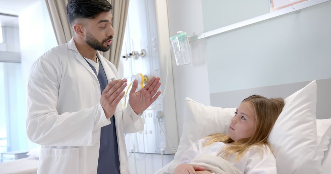 Male Doctor Explaining Treatment to Young Patient in Hospital - Free Images, Stock Photos and Pictures on Pikwizard.com