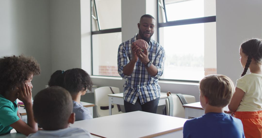 Image of happy african american male teacher and class of diverse pupils during biology lesson - Free Images, Stock Photos and Pictures on Pikwizard.com