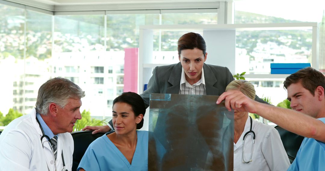 Medical Team Analyzing X-Ray in Hospital Meeting - Free Images, Stock Photos and Pictures on Pikwizard.com