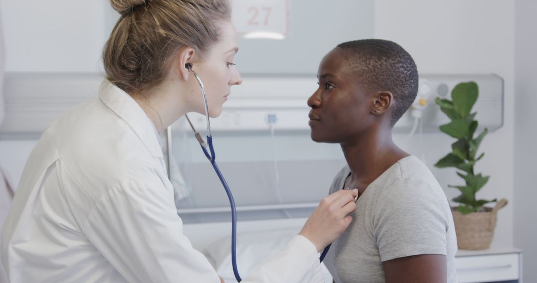 Female Doctor Examining Patient with Stethoscope in Clinic - Free Images, Stock Photos and Pictures on Pikwizard.com