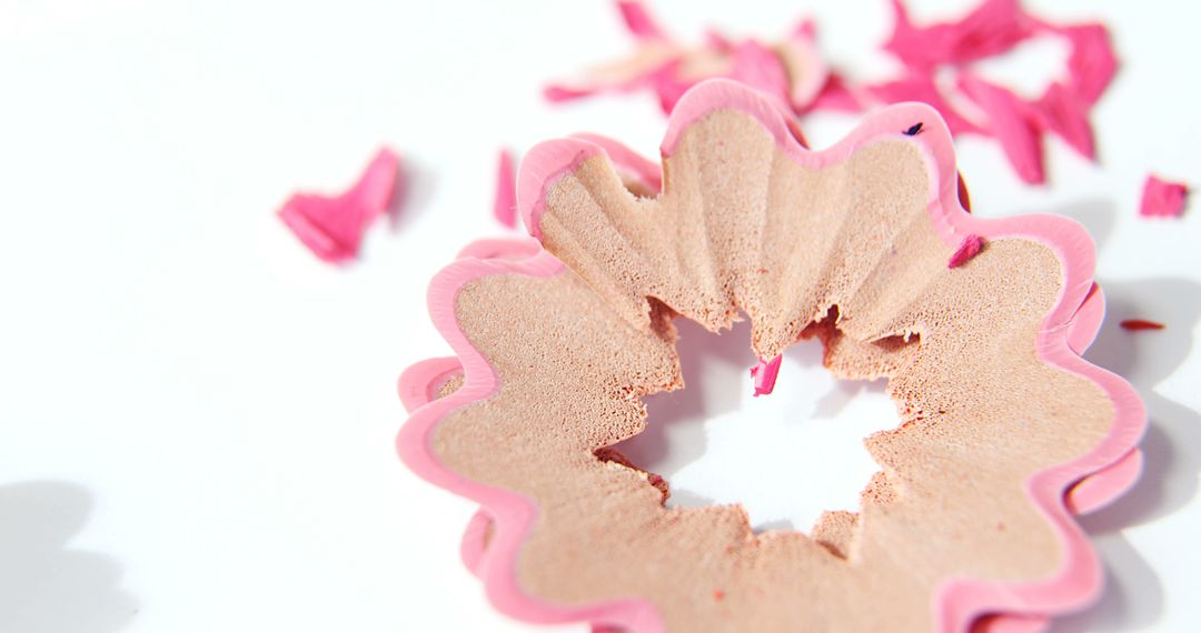 A close-up view of a pink pencil sharpener surrounded by shavings, with copy space - Free Images, Stock Photos and Pictures on Pikwizard.com