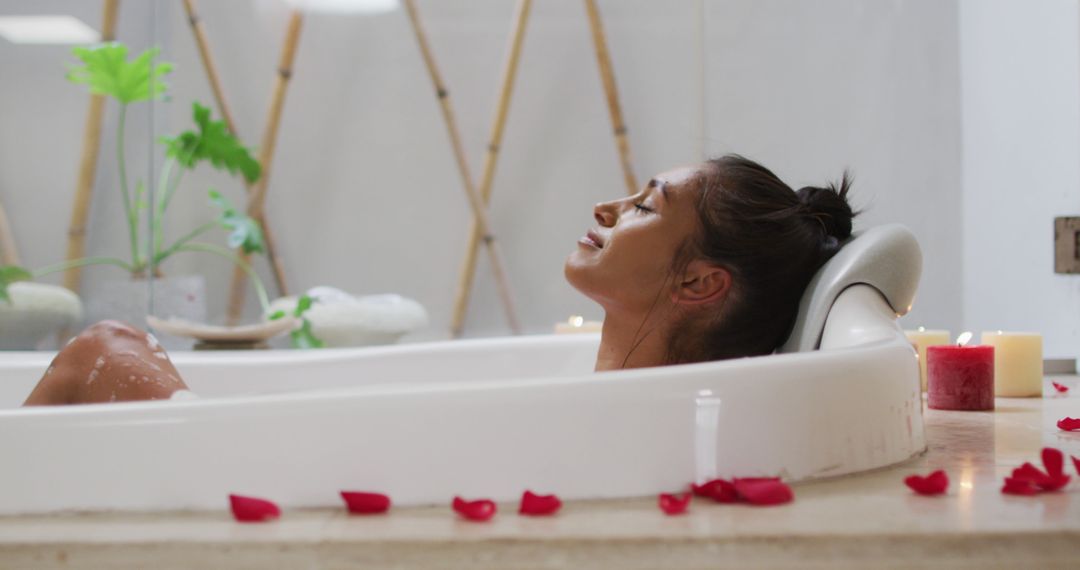 Woman Relaxing in Bathtub with Rose Petals and Candles in Spa Setting - Free Images, Stock Photos and Pictures on Pikwizard.com