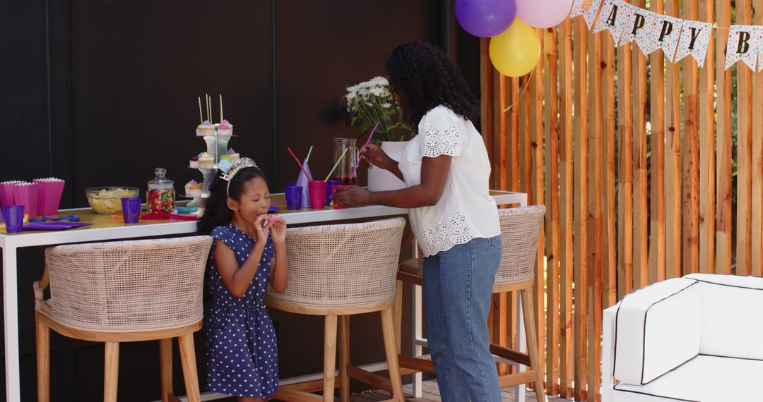 Mother and Daughter Preparing Colorful Party Table at Home