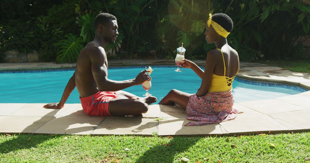 Couple Enjoying Drinks by Swimming Pool on Sunny Day - Free Images, Stock Photos and Pictures on Pikwizard.com