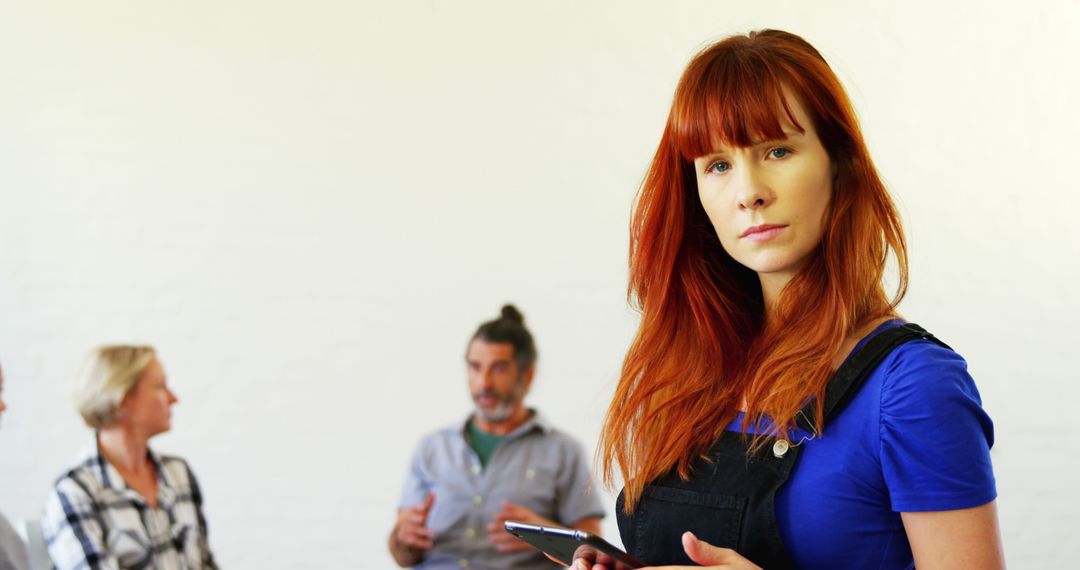 Portrait of Redhead Young Woman Holding Tablet in Office Environment - Free Images, Stock Photos and Pictures on Pikwizard.com