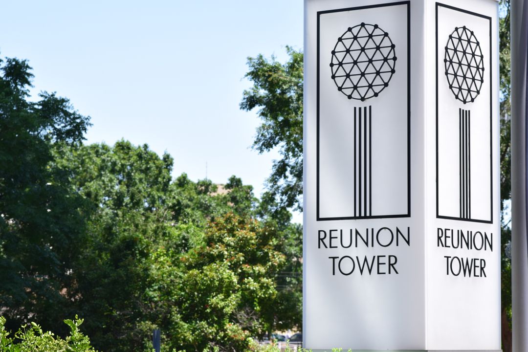 Exterior Signage of Reunion Tower against Green Foliage - Free Images, Stock Photos and Pictures on Pikwizard.com