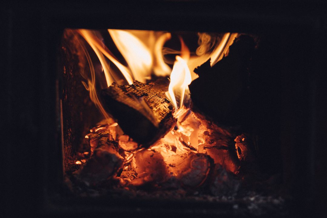 Cozy Warmth of Logs Burning in Fireplace with Glowing Embers