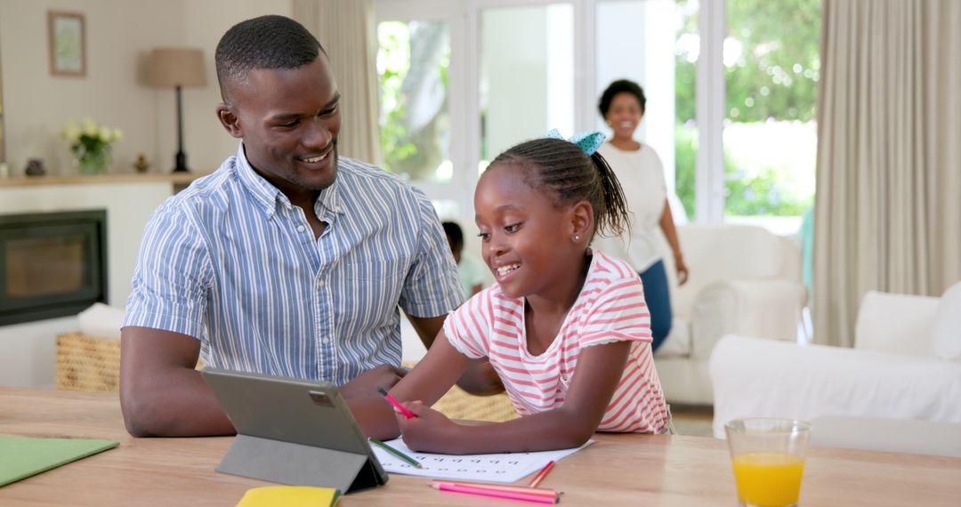 Father and Daughter Using Tablet for Homework