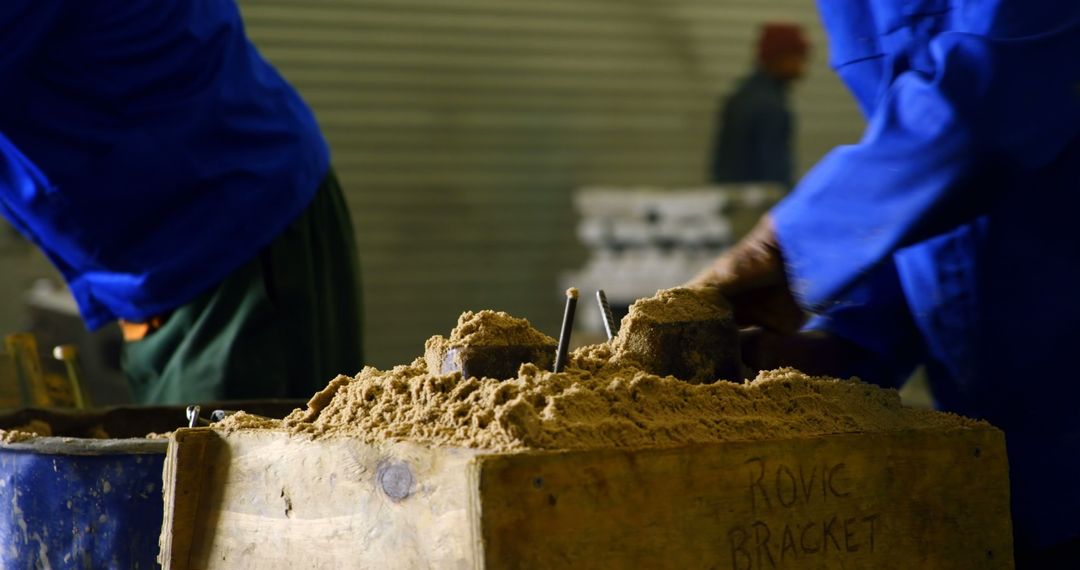 Close-up of Workers Molding Sand in Foundry - Free Images, Stock Photos and Pictures on Pikwizard.com