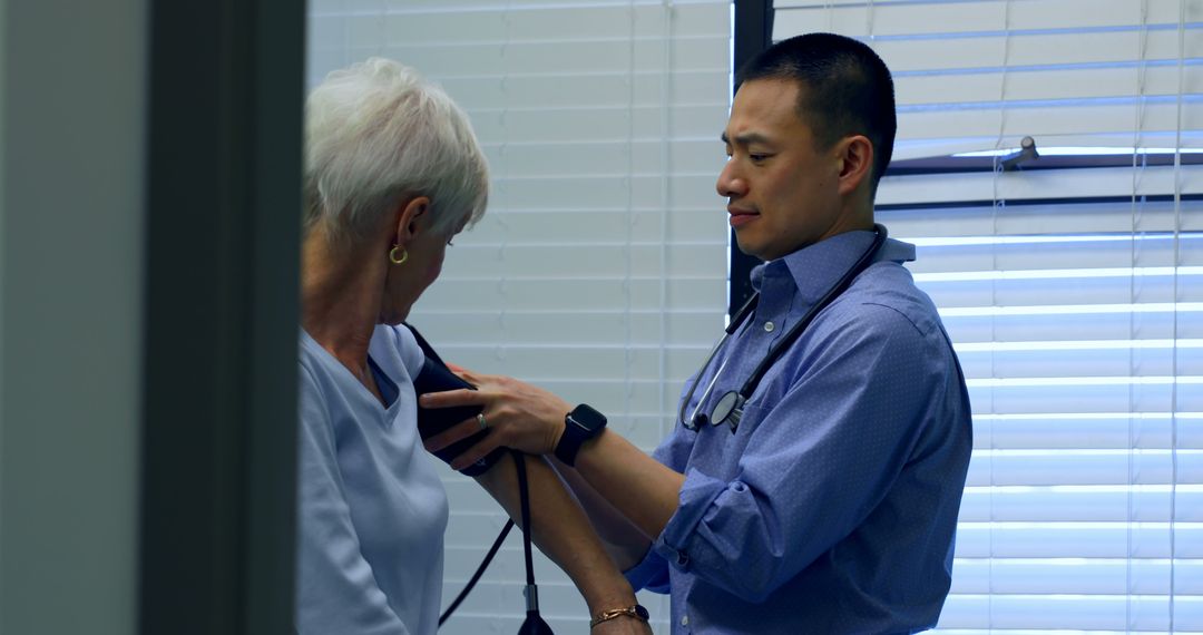 Doctor checking senior woman's blood pressure in clinic - Free Images, Stock Photos and Pictures on Pikwizard.com