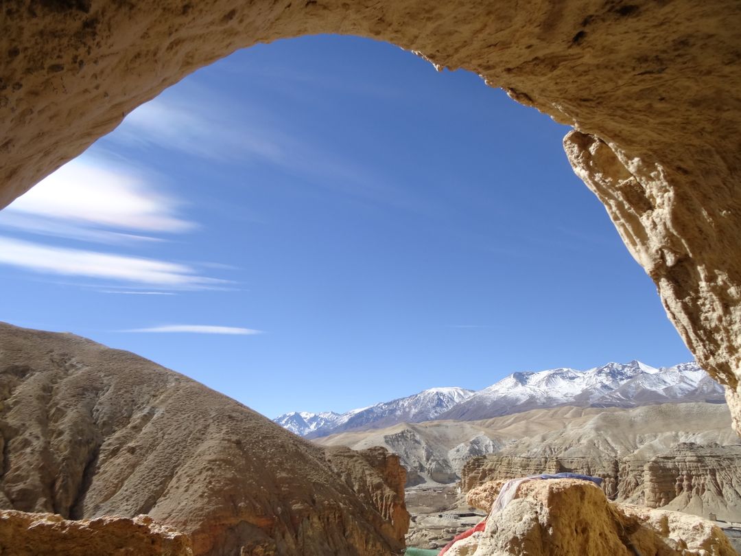 Mountain Landscape Framed by Cave Opening with Clear Blue Sky - Free Images, Stock Photos and Pictures on Pikwizard.com