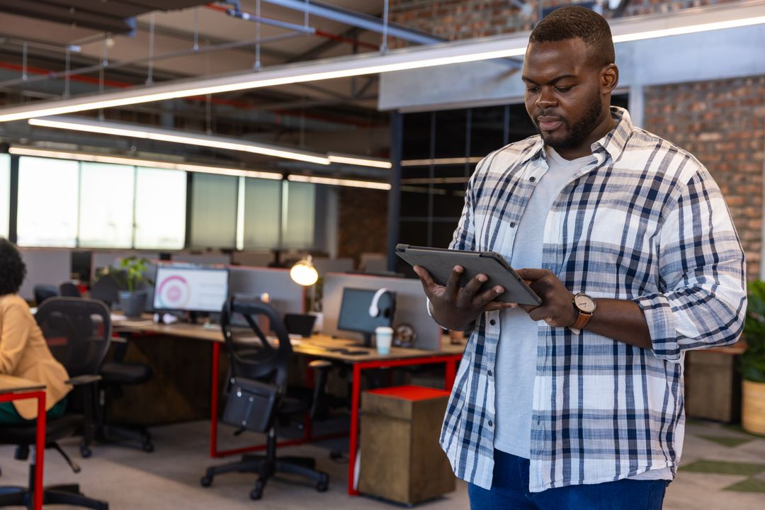 Professional Holding Tablet in Modern Office Setting