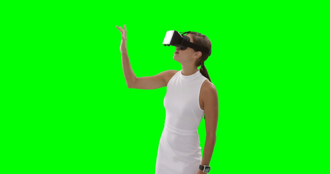 Woman Using Virtual Reality Headset with Raised Hand on Green Screen - Free Images, Stock Photos and Pictures on Pikwizard.com