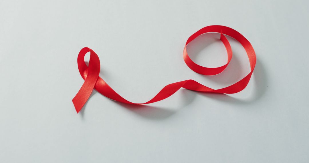 Red AIDS Awareness Ribbon on White Background - Free Images, Stock Photos and Pictures on Pikwizard.com