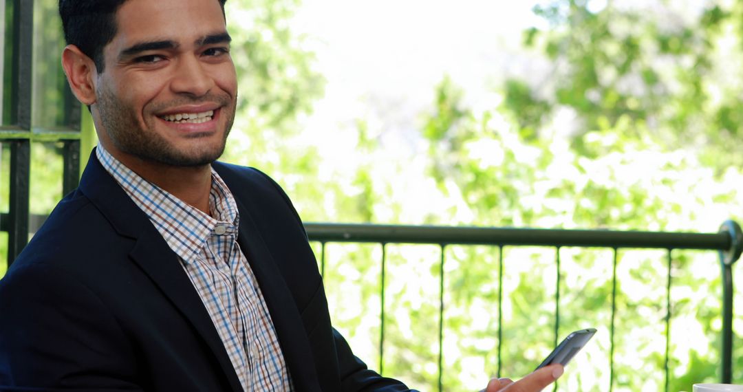 Smiling Man in Suit Using Smartphone Outdoors - Free Images, Stock Photos and Pictures on Pikwizard.com