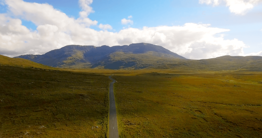 Scenic Transparent Road Stretching Through Lush Green Valley