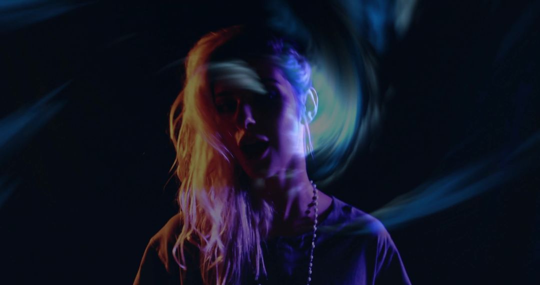 Woman Immersed in Abstract Light Projections