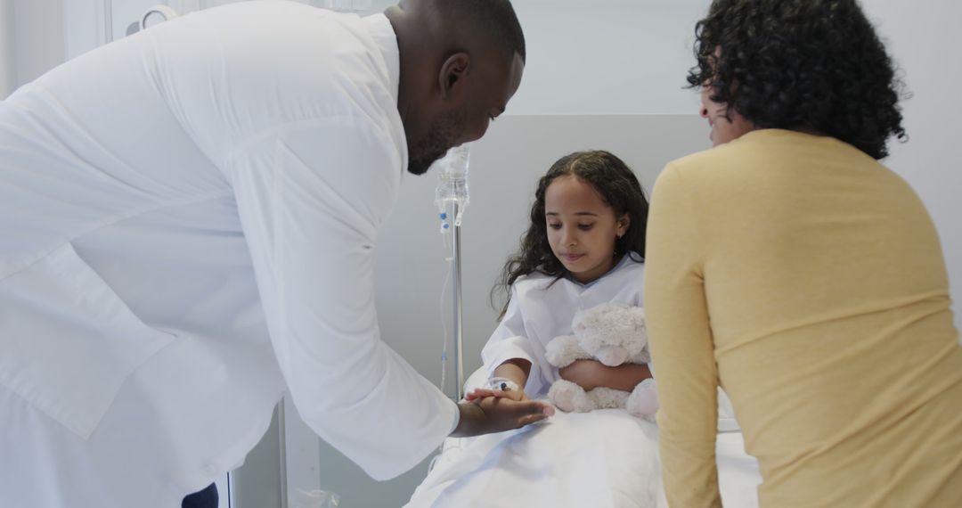 Doctor Comforting Child With Parent in Hospital Room - Free Images, Stock Photos and Pictures on Pikwizard.com