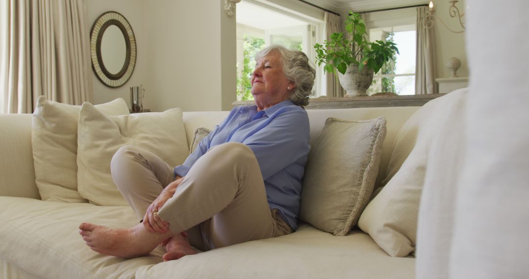 Senior Woman Meditating on Couch in Peaceful Home - Free Images, Stock Photos and Pictures on Pikwizard.com