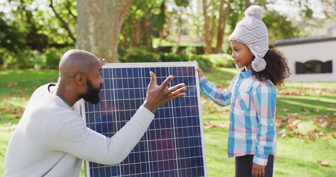 Father Teaching Daughter About Solar Energy in Backyard - Free Images, Stock Photos and Pictures on Pikwizard.com