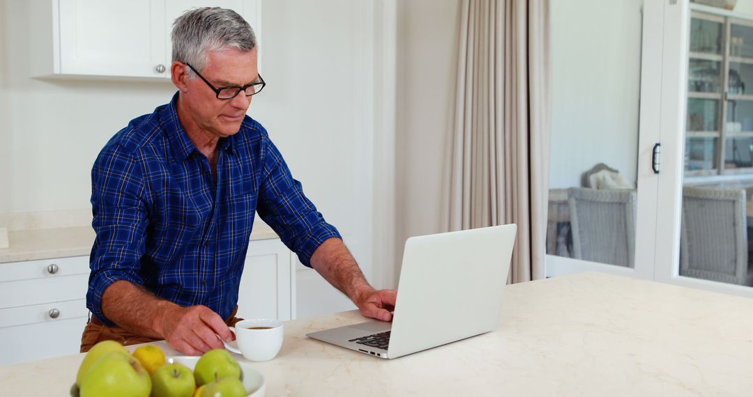 Senior Man Working on Laptop at Home with Coffee - Free Images, Stock Photos and Pictures on Pikwizard.com