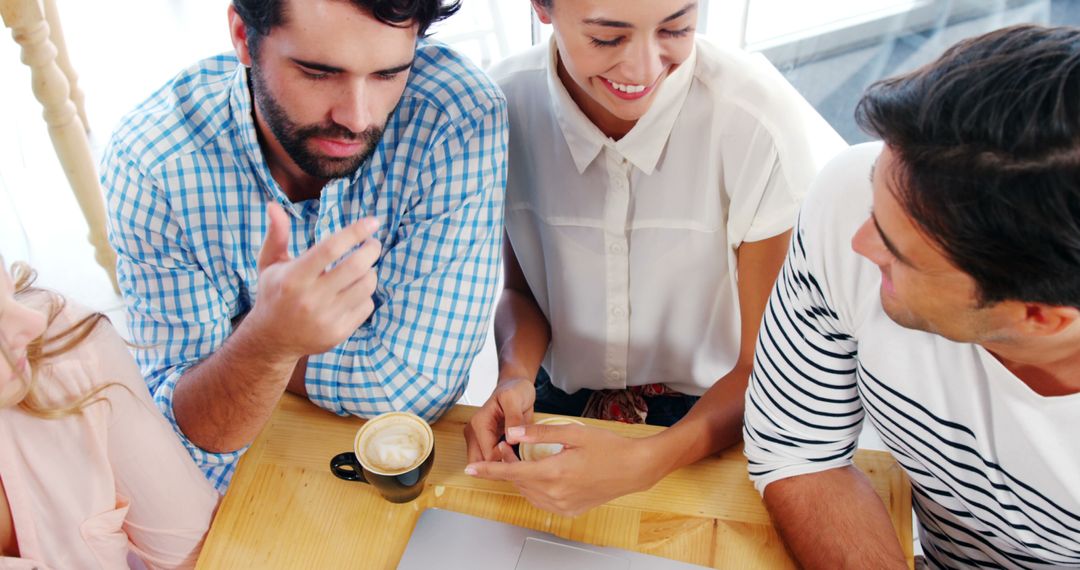 Group of Friends Discussing Project Over Coffee at Cafe