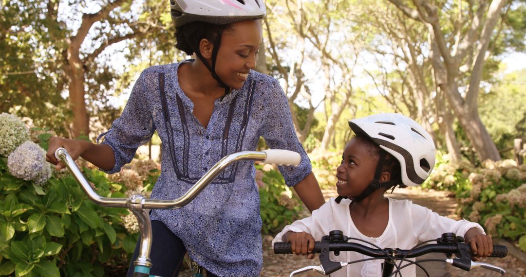 Smiling African American Mother and Daughter Riding Bicycles Outdoors - Free Images, Stock Photos and Pictures on Pikwizard.com