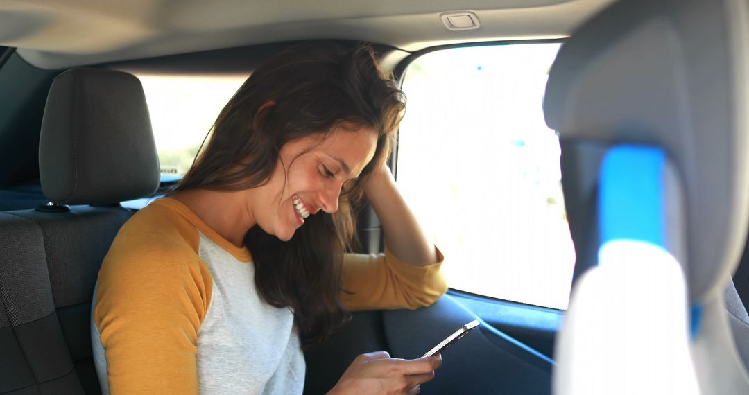 Smiling Woman Using Smartphone in Backseat of Car - Free Images, Stock Photos and Pictures on Pikwizard.com