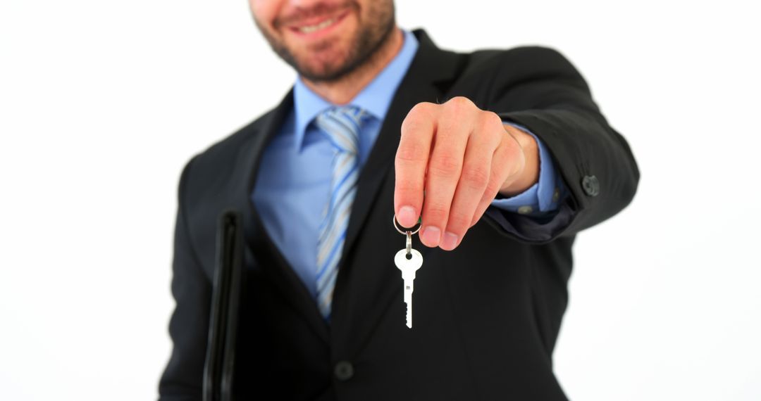 Smiling Businessman Holding House Key - Free Images, Stock Photos and Pictures on Pikwizard.com