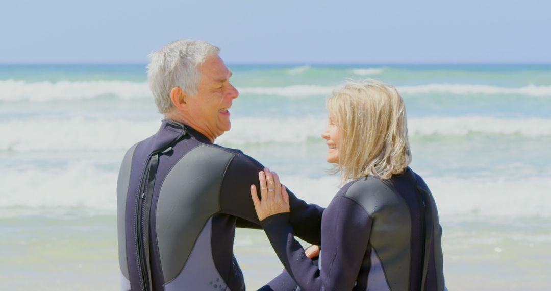Elderly Couple Enjoying Beach Day in Wetsuits
