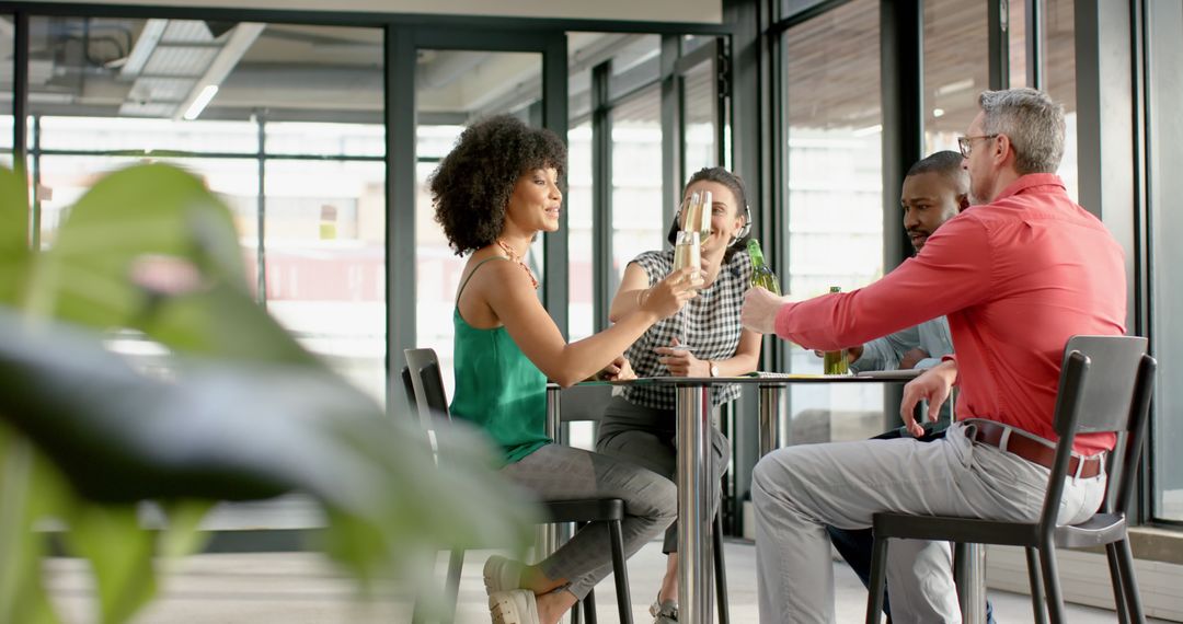 Diverse Colleagues Toasting Drinks in Modern Office Space