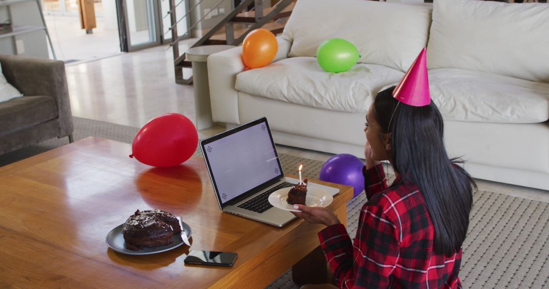 Woman Celebrating Virtual Birthday Party with Laptop and Cake at Home - Free Images, Stock Photos and Pictures on Pikwizard.com