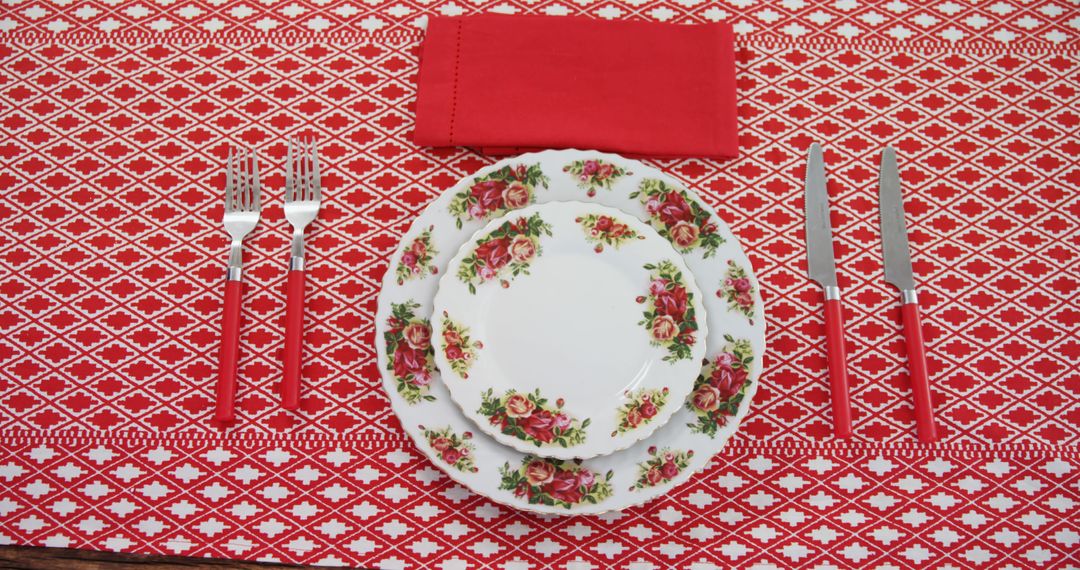 Vintage Floral Dinnerware on Red Patterned Tablecloth - Free Images, Stock Photos and Pictures on Pikwizard.com