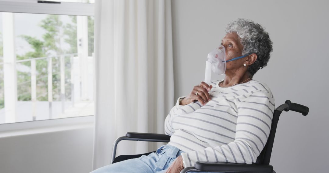 Elderly Woman Using Oxygen Mask in Wheelchair at Home Near Window - Free Images, Stock Photos and Pictures on Pikwizard.com