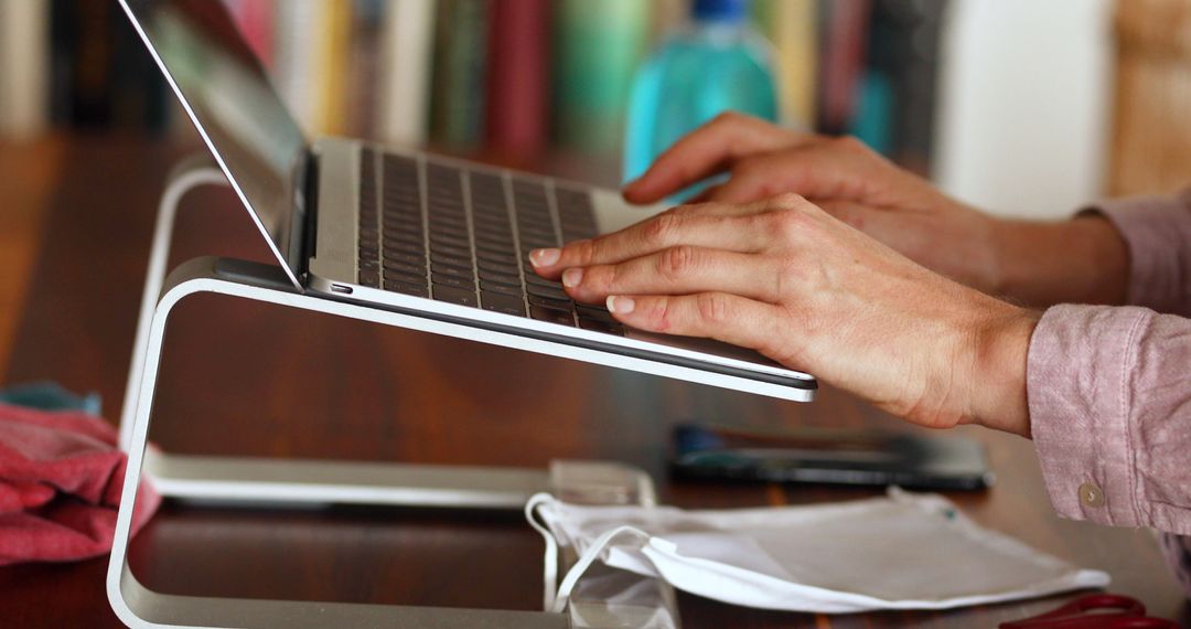 Person Typing on Laptop with Stand at Home Office - Free Images, Stock Photos and Pictures on Pikwizard.com