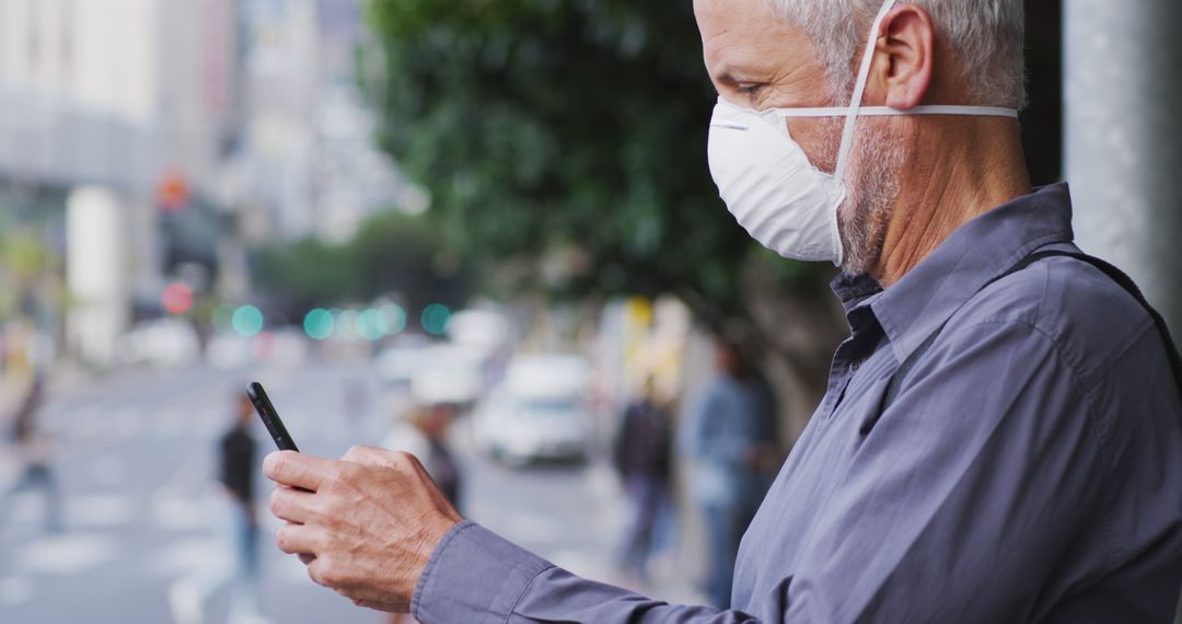 Mature Man Wearing Face Mask Texting on Urban Street - Free Images, Stock Photos and Pictures on Pikwizard.com