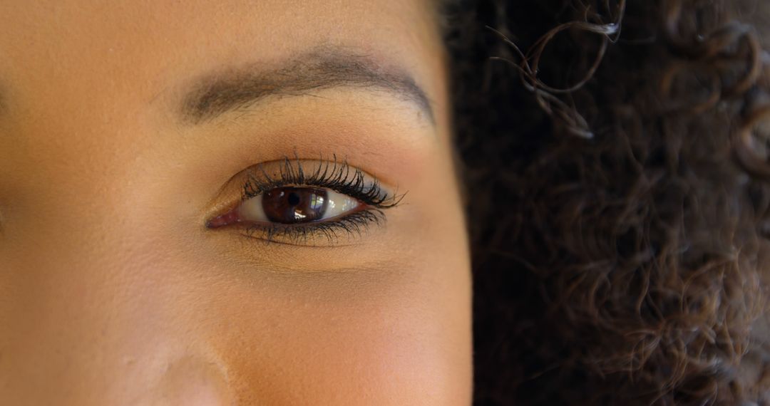 Close-up of One Eye with Long Eyelashes and Curly Hair - Free Images, Stock Photos and Pictures on Pikwizard.com