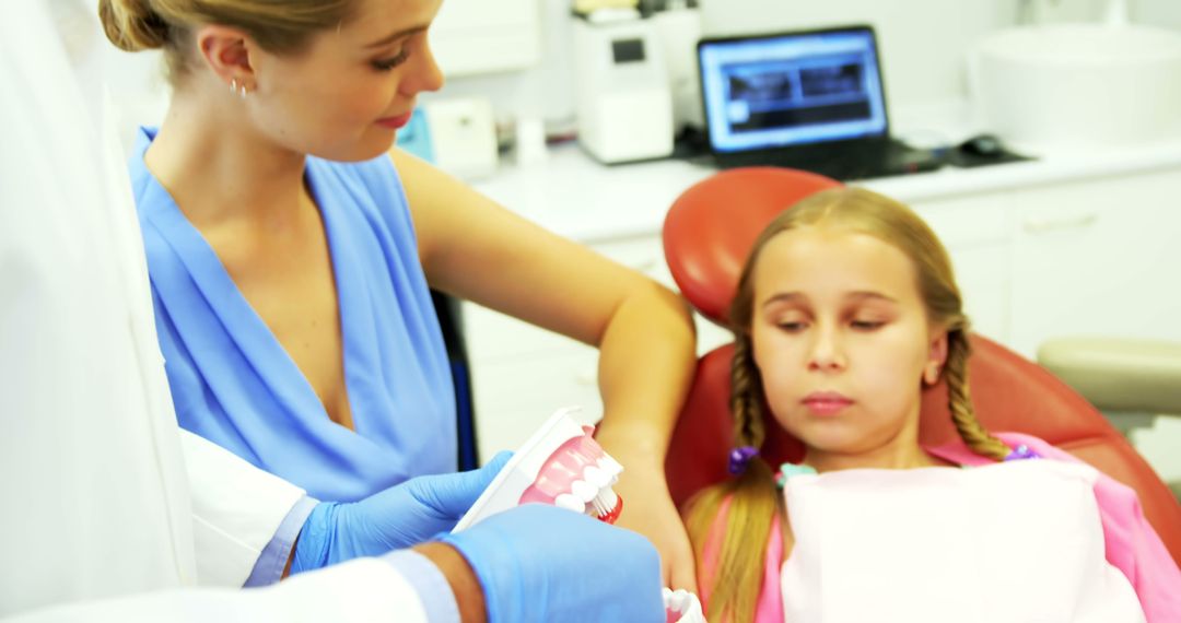 Little girl at dentist learning about oral care from professional - Free Images, Stock Photos and Pictures on Pikwizard.com