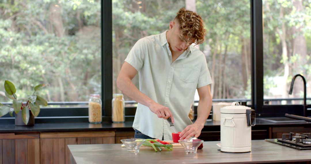 Man Preparing Meal with Fresh Veggies in Bright Kitchen